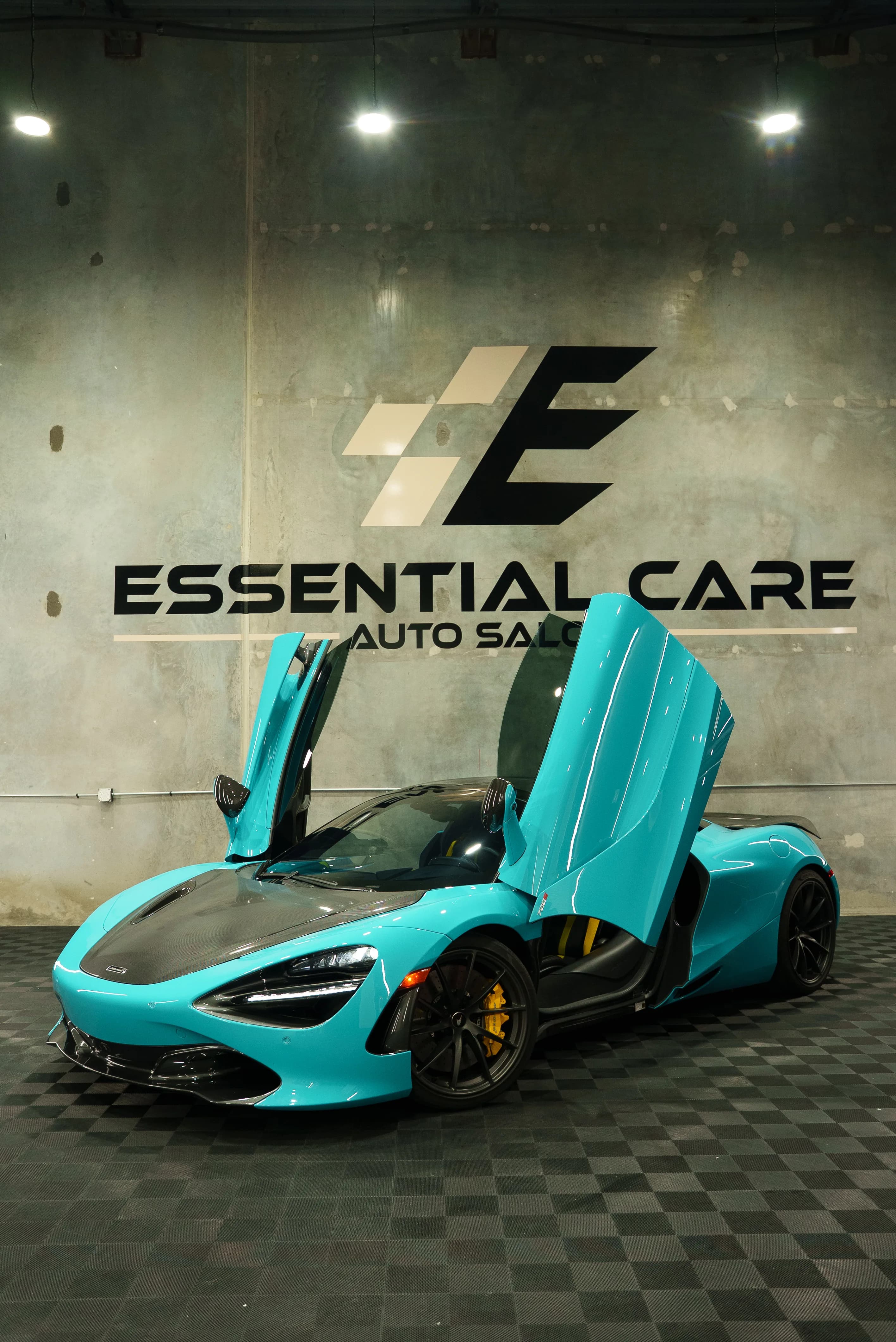 Teal McLaren 720S with a custom color-change wrap, doors up, at Essential Care Auto Salon