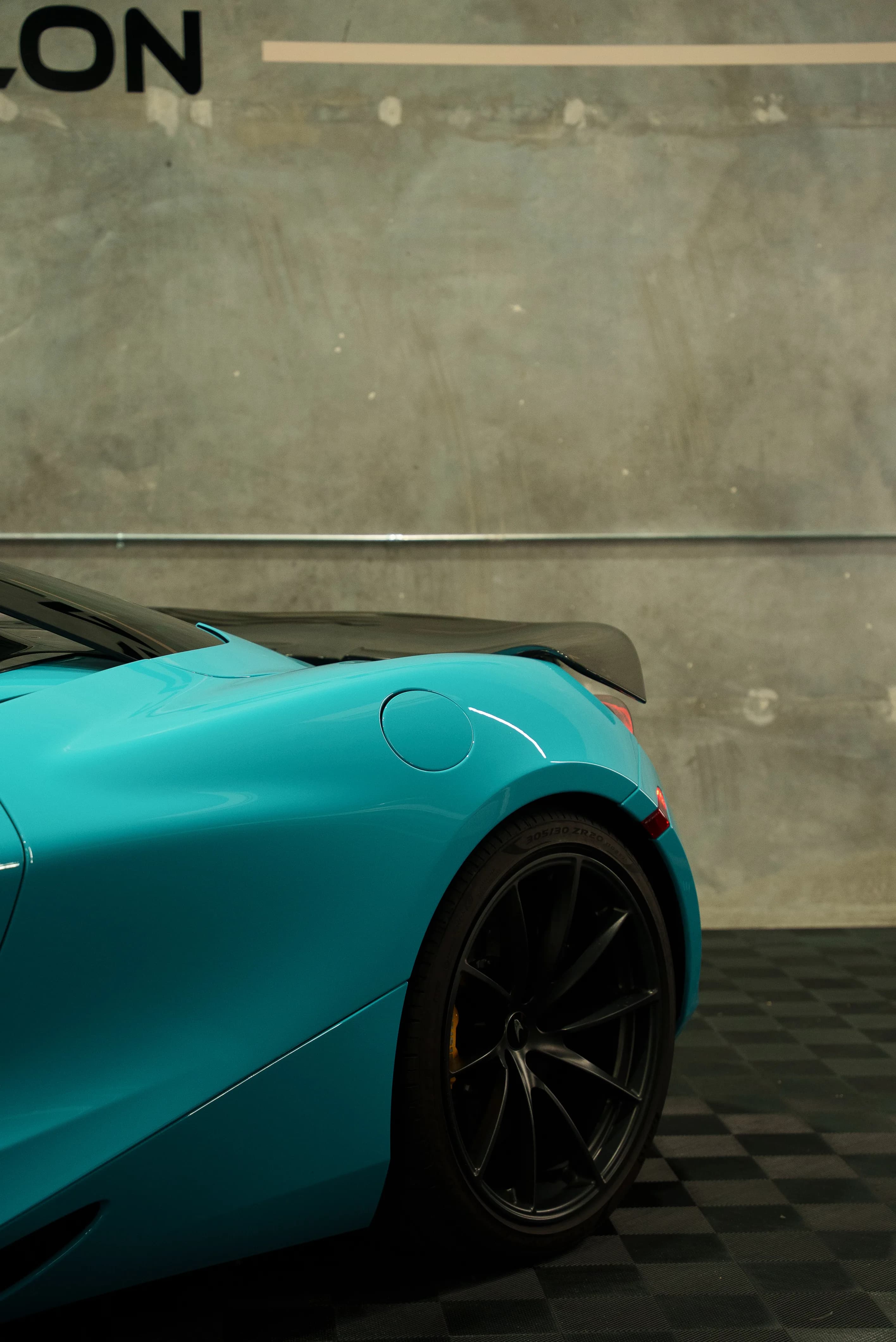 Rear quarter of a teal-wrapped McLaren 720S